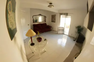 a living room with a couch and a table at apartemento ideal familia y grupo climatisacion playa poblaA in Valencia