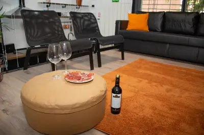 a living room with a bottle of wine and wine glasses at Soraya's Place - Chopín 2 in Valencia