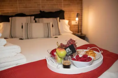 a tray of fruit on a bed in a hotel room at Soraya's Place - Chopín 2 in Valencia