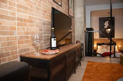 a bottle of wine and a wine glass on a table at Soraya's Place - Chopín 2 in Valencia