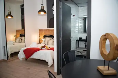 a bedroom with a bed and a large mirror at Soraya's Place - Chopín 2 in Valencia