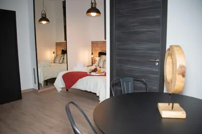 a room with a bed and a table and a mirror at Soraya's Place - Chopín 2 in Valencia