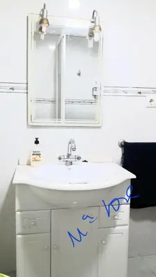 a bathroom with a white sink and a mirror at Alquiler Universidades Malvarrosa Playa Maritim Valencia Solo para familias con niños in Valencia