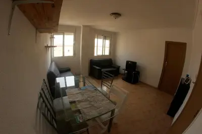 an aerial view of a living room with a table and chairs at apartemento ideal grupo y familia climatisacion y cerca playa . mongrell in Valencia