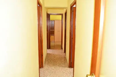 a hallway with a row of doors and a hallwayngthngthngthngthngthngth at Apartemento grupo amigo o familias : blasco ibanez C in Valencia