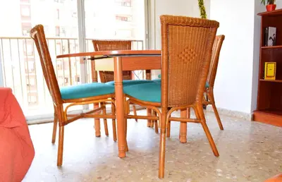 a dining room table with two chairs and a table at Apartemento grupo amigo o familias : blasco ibanez C in Valencia
