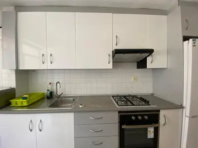 a kitchen with white cabinets and a stove top oven at piso para jovenes familia cerca playa y centro . BLASCO IBANEZ A in Valencia