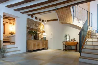 a living room with a staircase and a table at Los Canilleros in Requena
