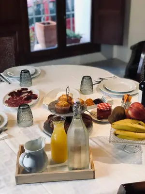 a table topped with plates of food and fruit at Los Canilleros in Requena
