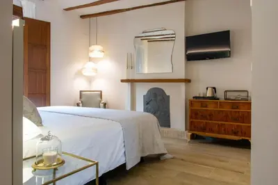 a bedroom with a bed and a fireplace at Los Canilleros in Requena