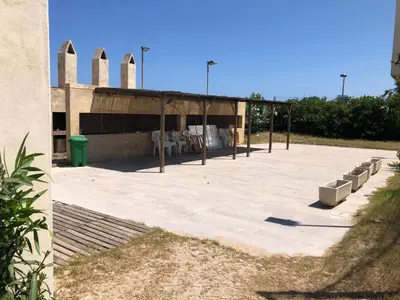 a large patio with a building in the background at Apartamento de playa Valmar - Beachfront exclusive residential in El Perellonet