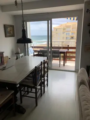 a dining room with a table and a view of the ocean at Apartamento de playa Valmar - Beachfront exclusive residential in El Perellonet