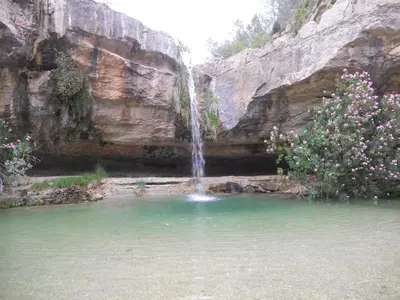 a waterfall in the middle of a pool of water at Villa Conchin Casa junto a Parque Natural in Alberique