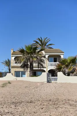 a house on the beach with palm trees at Beach House Villa Roca in Cullera