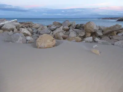 a pile of rocks on a sandy beach at Beach House Villa Roca in Cullera