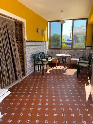 a room with chairs and a table and windows at 1era linea de playa VILLA MARGARET Cullera Marenyet in Cullera