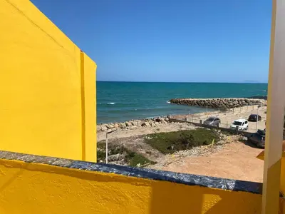 a view of the ocean from a yellow balcony at 1era linea de playa VILLA MARGARET Cullera Marenyet in Cullera