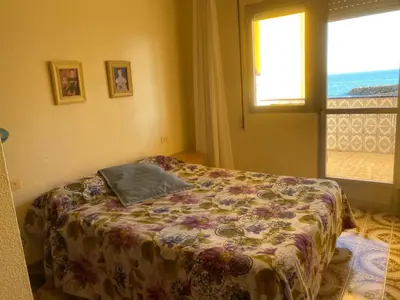 a bedroom with a bed with a pillow on it at 1era linea de playa VILLA MARGARET Cullera Marenyet in Cullera