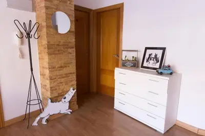 a room with a dresser and a dog in it at Precioso atico en pleno centro de Valencia in Valencia