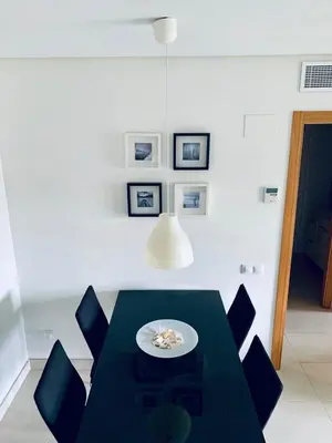 a dining room with a black table and chairs at NON STRESS Ático Dúplex con vistas al MAR in Valencia