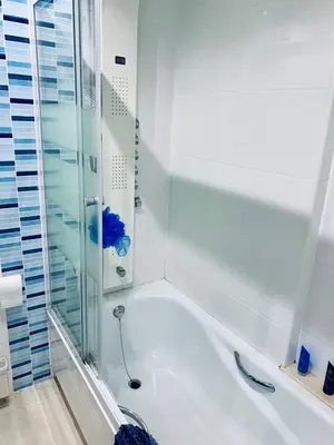 a bathroom with a shower and a bath tub at NON STRESS Ático Dúplex con vistas al MAR in Valencia