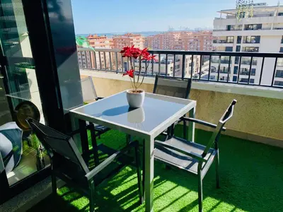 a white table and chairs on a balcony with a view at NON STRESS Ático Dúplex con vistas al MAR in Valencia