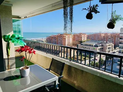 a balcony with a table and a view of a city at NON STRESS Ático Dúplex con vistas al MAR in Valencia