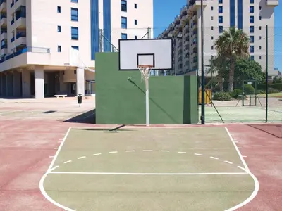 a basketball court with a hoop in a city at ApartUP Patacona Essence in Valencia