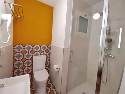 a bathroom with a toilet and a shower in it at Hotel 19-30 Valencia in Valencia