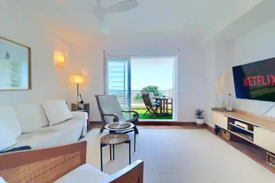 a living room with a couch and a table at Casa frente al mar con piscina privada in Sagunto