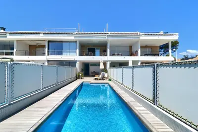 an apartment with a swimming pool on the balcony of a building at Casa frente al mar con piscina privada in Sagunto