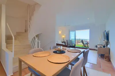 a dining room with a table and chairs at Casa frente al mar con piscina privada in Sagunto