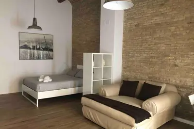 a living room with a couch and a bed at Fantástico Loft en centro ciudad planta baja in Valencia