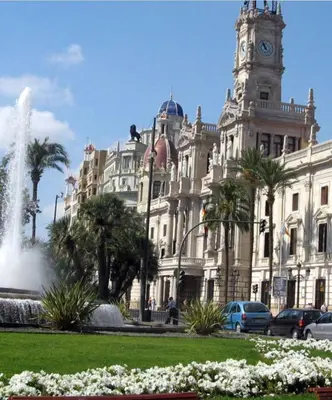a building with a clock tower and a fountain in front of it at Fantástico Loft en centro ciudad planta baja in Valencia