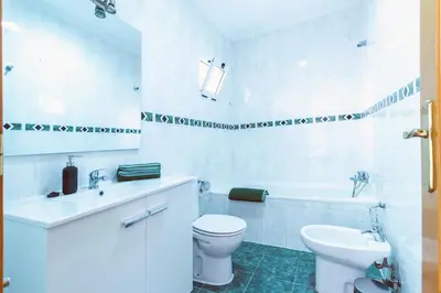 a white bathroom with a toilet and a sink at Design, beach and city center in Valencia