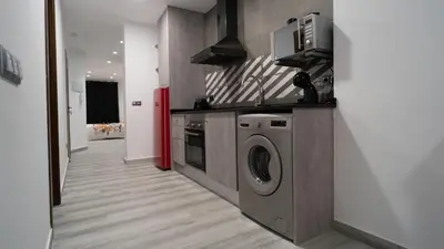 a kitchen with a washing machine and a microwave at Star Anna in Anna
