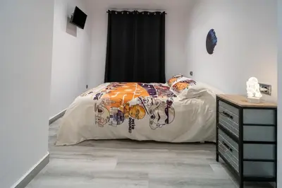 a bedroom with a bed with a comforter on it at Star Anna in Anna