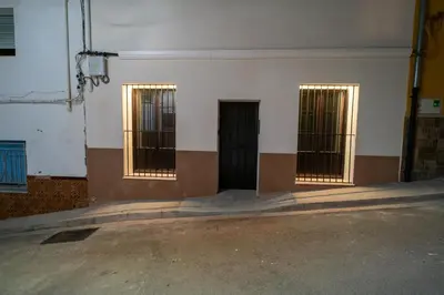 a white wall with three doors with bars on them at Star Anna in Anna