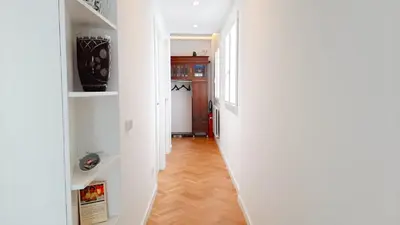 a hallway with white walls and wooden floors at Valencia Town Hall Dream in Valencia