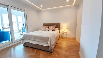 a bedroom with a bed and a large window at Valencia Town Hall Dream in Valencia