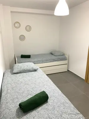 a bedroom with two beds with green towels on them at UIM Mediterraneo PB Segorbe Wifi in Puerto de Sagunto