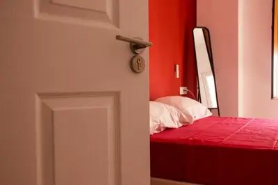 a door leading to a bedroom with a bed at Colors Rooms in Valencia