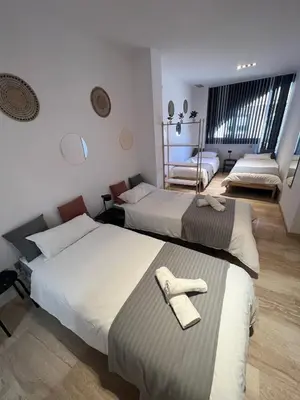 a bedroom with two beds with towels on them at Pensión Les Eres in Puebla de Vallbona