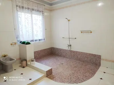 a bathroom with a shower and a toilet and a window at Casa MarTa in Chella