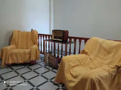a room with two chairs and a tv on a balcony at Casa MarTa in Chella