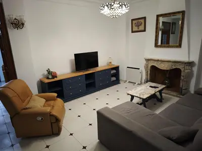 a living room with a couch and a tv on a dresser at Casa MarTa in Chella