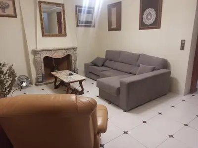a living room with a couch and a fireplace at Casa MarTa in Chella