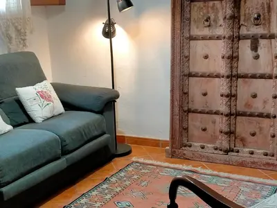 a living room with a couch and a door at Ca'n Josep in Segorbe