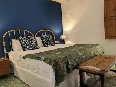 a bedroom with a large bed with blue walls at Ca'n Josep in Segorbe
