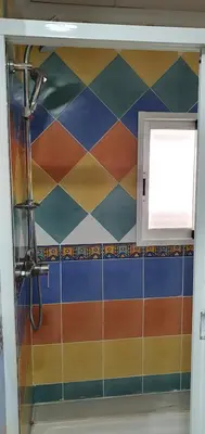 a bathroom with a checkered tile wall at Maravisa in Puebla de Vallbona